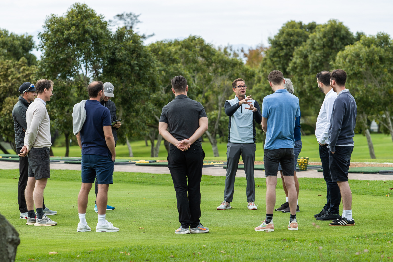 Cameron Venter speaking to a group on a golf course